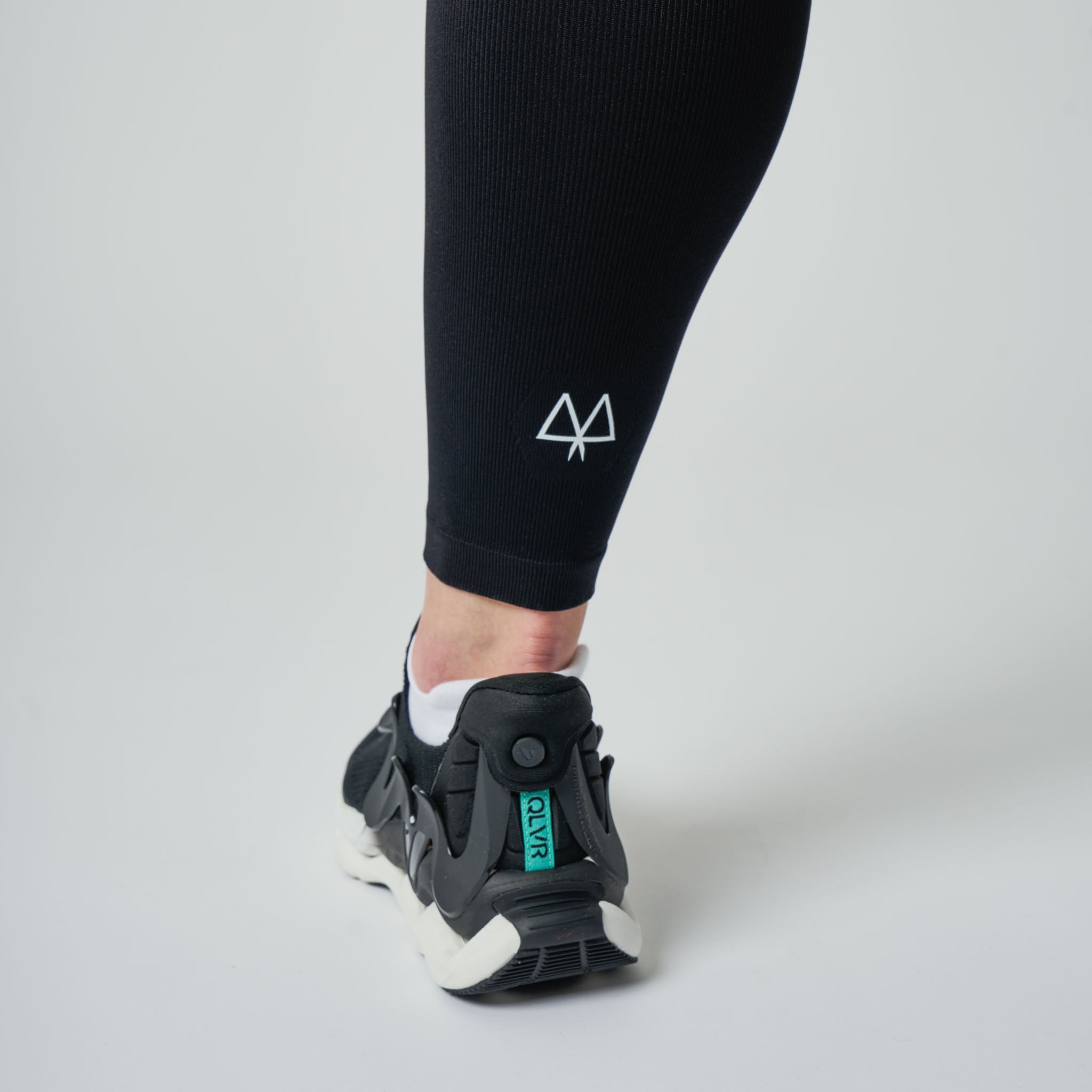 Black athletic shoe with a visible MAAREE logo on a light gray background
