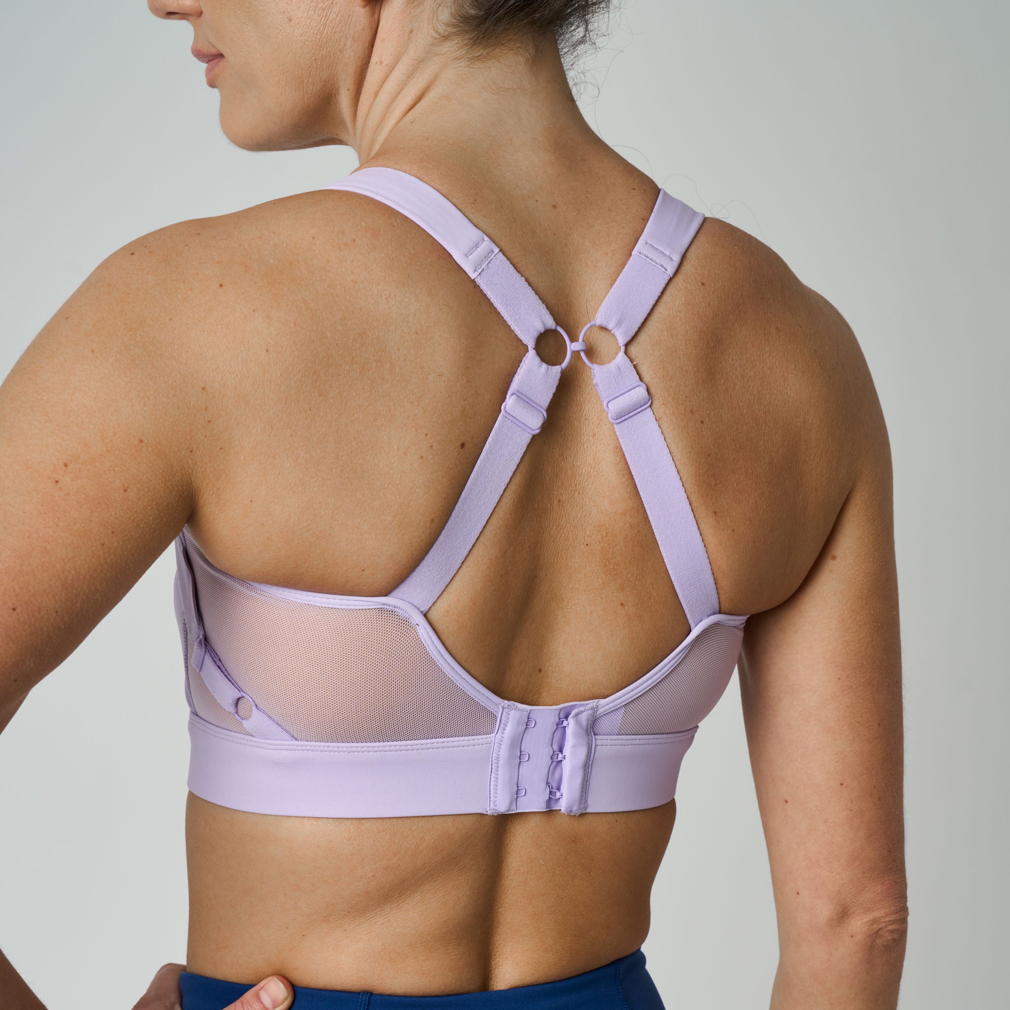 Lavender sports bra worn by a person on a plain background