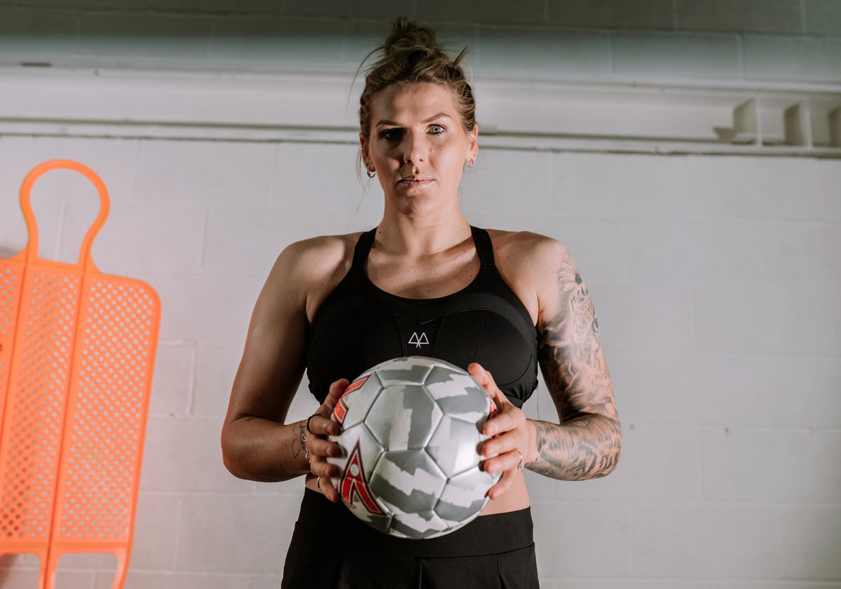 Millie_bright_lioness_chelsea_captain_holding_football_wearing_black_maaree_solidarity_sports_bra